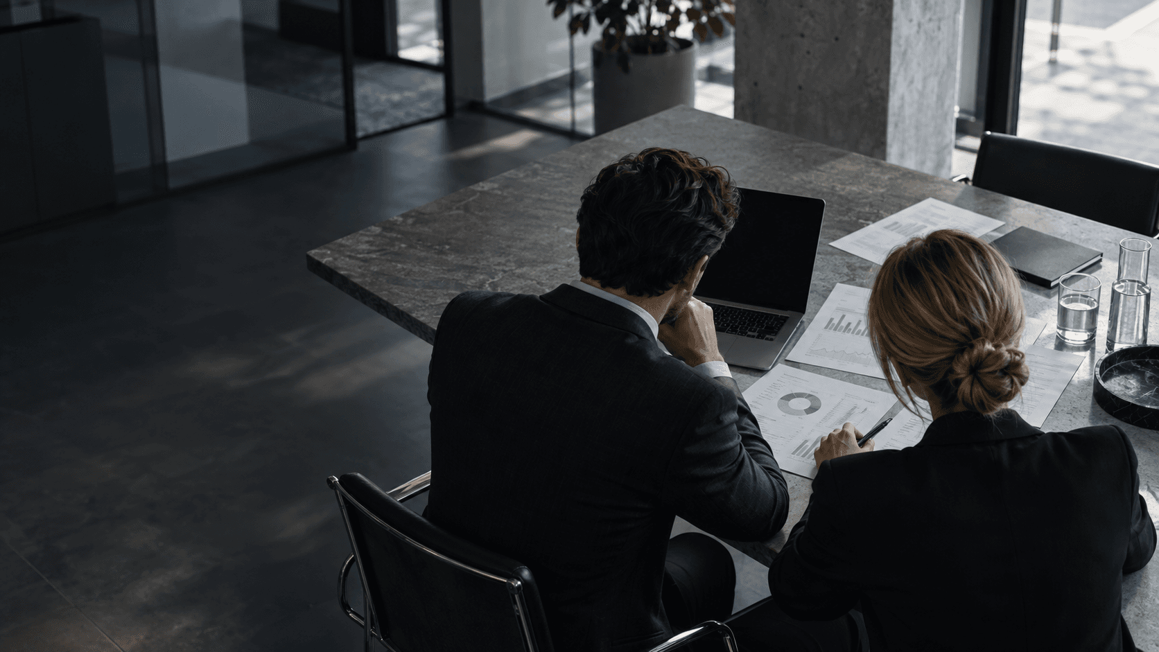 Art-directed view of two colleagues reviewing financial reports
